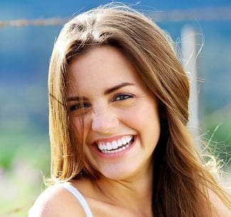 a girl smiling wearing clear aligners