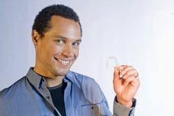 a man holding a clear aligner